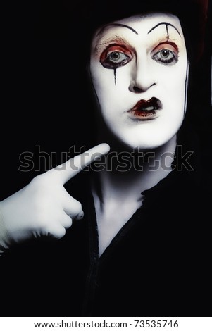 grimace theatrical actor with dark makeup on her face