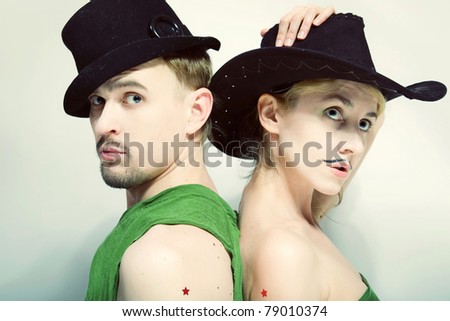 Double studio portrait of a man and a woman with a theatrical makeup closeup
