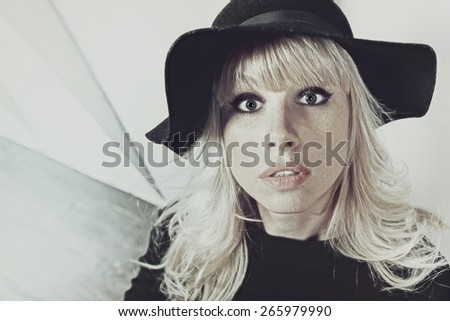 Funny portrait of a young frightened woman