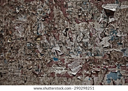 Texture of wooden boards with scraps of old ads