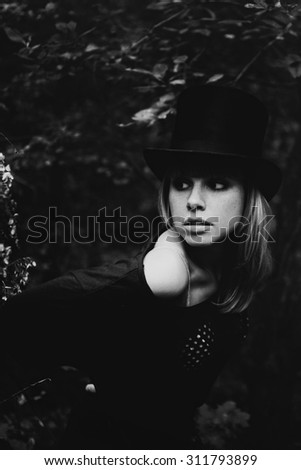Portrait of a beautiful young woman wearing a high hat