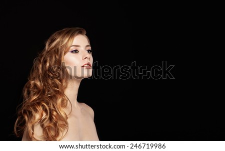 Hair. Beauty Woman with Very Long Healthy and Shiny Curly Red Hair. Model Red Girl Portrait isolated on a black background. Gorgeous Hair,curly hair