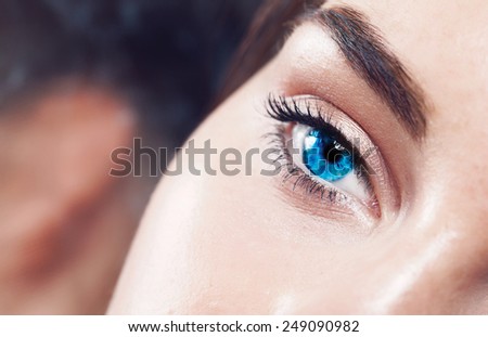 Extreme closeup shot of a beautiful woman  bright blue eye