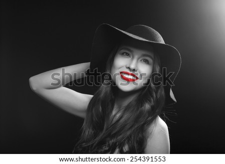 High fashion look.glamour portrait of beautiful sexy smiling young female woman with red lips on black background with hat