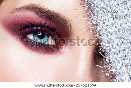 Blue eyes closeup.Beautiful fashion girl with arrow make up. Closeup female eye with beautiful fashion bright makeup