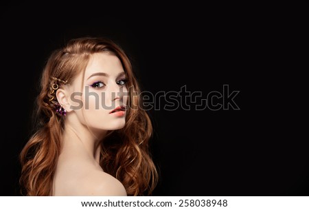 Hair. Beauty Woman with Very Long Healthy and Shiny Curly Red Hair. Model Red Girl Portrait isolated on a black background. Gorgeous Hair