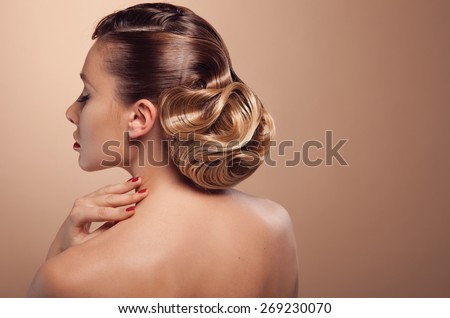 Beautiful woman with evening make-up and salon hairdo . Smoky eyes. Complicated hairstyle for party
