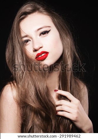 Young fashion woman with red lips and manicure, shine hair. Studio shot. Brown eyes. Classic portrait of model.