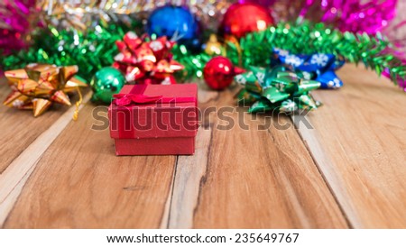 Red gift box decorations for Christmas and New Year on a wooden floor. Used for the background.