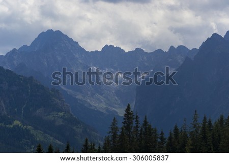 View of mountain peaks and a hill. Mountain trail in Tatry mountains, Poland. Trail towards Rusinowa Polana. Tatra National Park (Polish: Tatrzanski Park Narodowy)