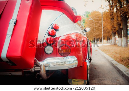red and white retro cabriolet car closeup view, outdoors photo, stop signal lamp