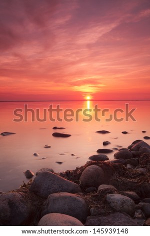 Beautiful baltic sea sunrise, the sun is breaking through the clouds