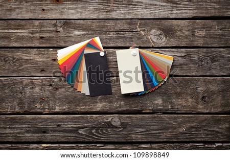 Two designer color swatches on old wooden background.