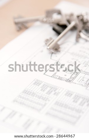 Architectural blueprint of house plan with bunch of keys on the table. Closeup.