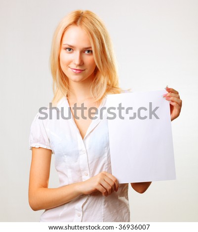 Beautiful smiling blond woman showing blank paper sheet. Closeup. Isolated.
