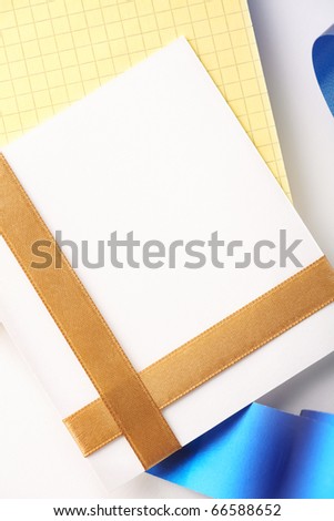 Blank greeting card on blank yellow spiral note book.