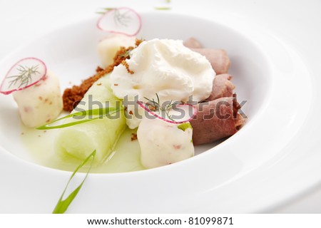 Thin slices of beef with vegetables and thick sour cream sauce