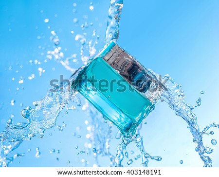 The blue  jar of moisturizing cream with big  blue water splash  and many water  drops around the jar  on the blue gradient background