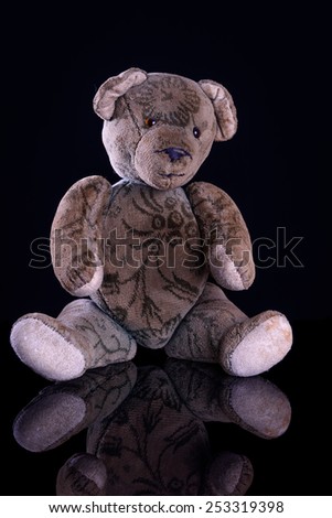 Antique Teddy on reflective black base