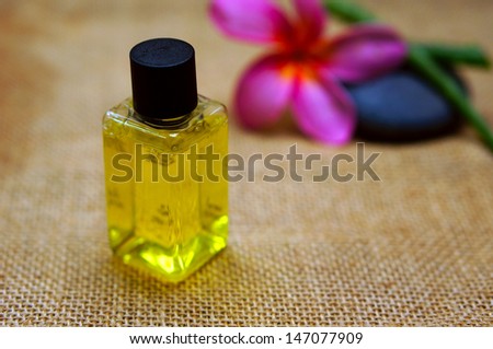 Tropical spa concept with plumeria flower and stones n brown jute background
