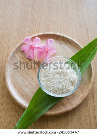 Thai rice in the glass bowl with green leaf and flower means richness in nature of Thailand