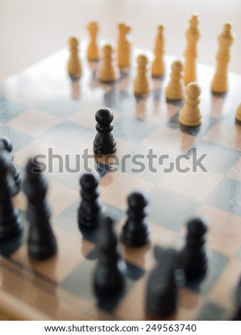 Black chess in the center of board, Shallow in depth of field