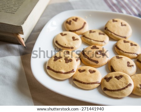 Homemade smile cookie with blured text book on the bed, Good morning concept