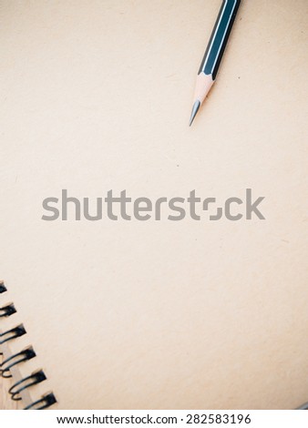 Pencil on ring binding notebook with recycle brown paper for cover page,Selective focus on pencil sharpness, Film-like filter process