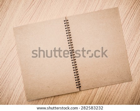 Ring binding notebook with recycle brown paper for cover page on Wooden background, Tonal contrast process