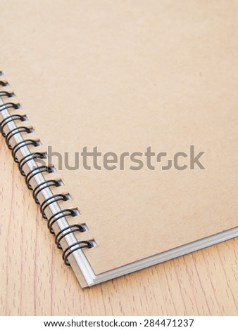 Ring binding notebook with recycle brown paper for cover on wooden background, Shallow in depth of field