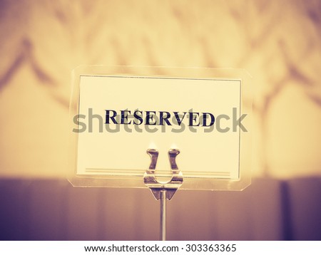 Reserved sign with holder in restaurant, Vintage style