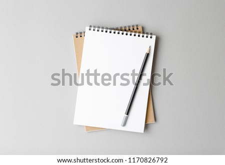 top view of a open notebook with pencil on a gray background, school notebooks with a spiral spring, office notepad flat lay