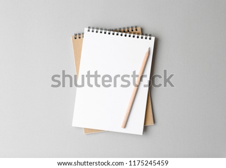 top view of a open notebook with pencil on a gray background, school notebooks with a spiral spring, office notepad flat lay