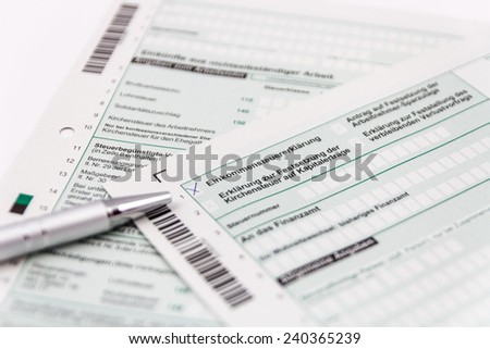 Form of income tax return with ball pen and short depth of sharpness
