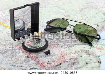 Compass and pilot sunglasses on a hiking map of the Berchtesgaden Alps