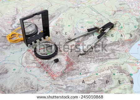 Compass and divider caliper on a hiking map of the Berchtesgaden Alps