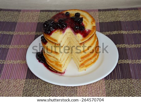 Fluffy pancakes with syrup on wooden table