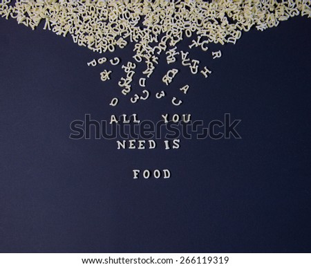 Words All You Need Is Food Written With Pasta Letters ,on a black background