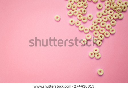Cereal rings on pink background