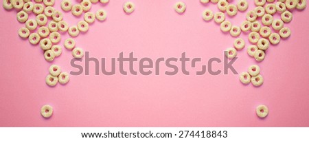 Cereal rings on pink background
