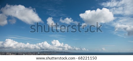 Blue sky with white fluffy clouds at noon