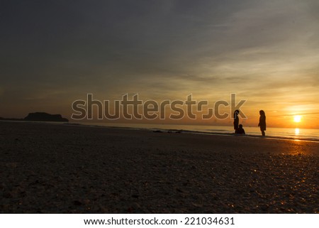 Kid shadow figure in the sunset sea.