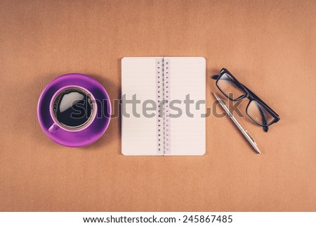 Vintage color. Office table with notepad, computer and coffee cup. View from above with copy space.View from above