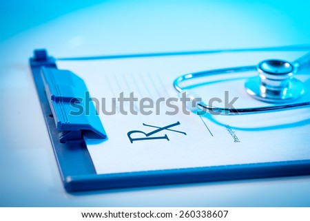 Medical questionnaire, stethoscope on blue background. Empty medical prescription