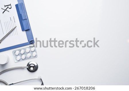 Empty medical prescription with a stethoscope on white background. Medical concept with copy space