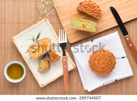 Mid-Autumn Festival moon cake on wooden board. Mooncake and tea,Chinese mid autumn festival food. angle view from above