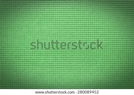 Abstract green background from synthetic fabric in black shadow