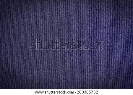 Abstract dark blue color background from synthetic fabric in black shadow