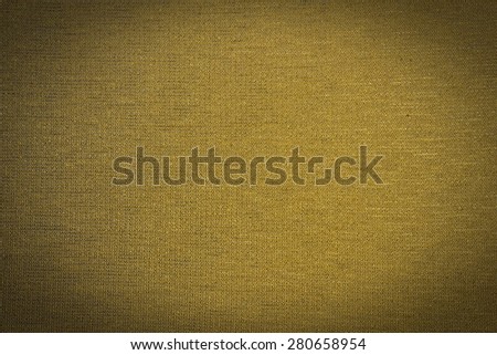 Abstract yellow background from synthetic fabric in black shadow