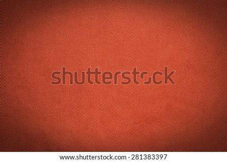 Abstract red background from synthetic fabric in black shadow
